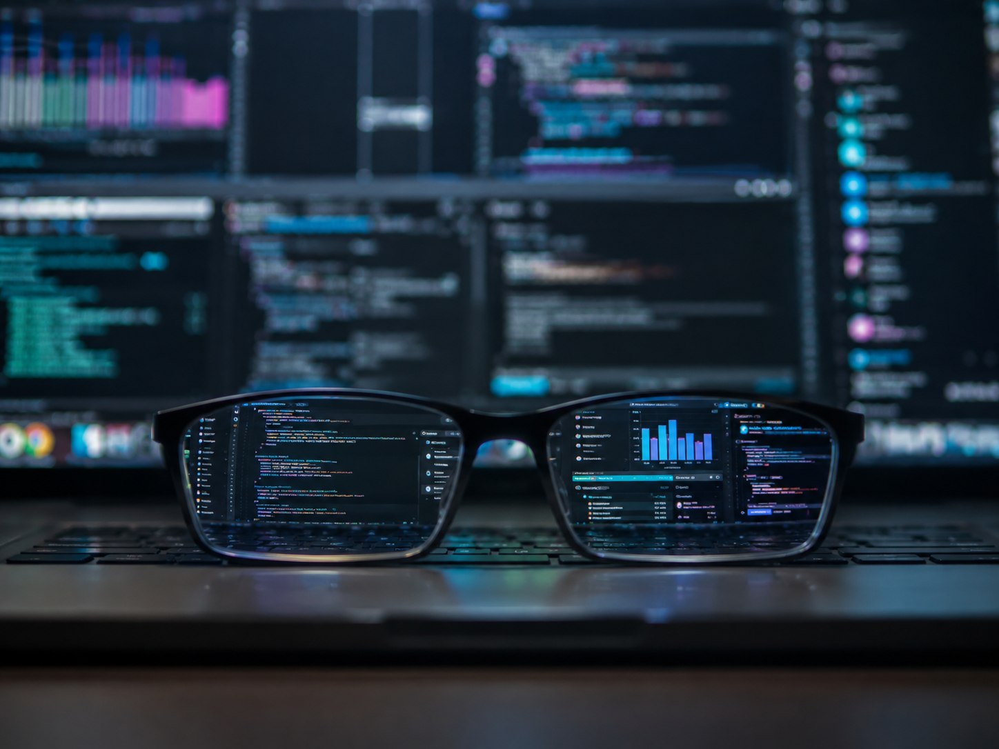 Eyeglasses reflecting a software workspace on a computer screen.